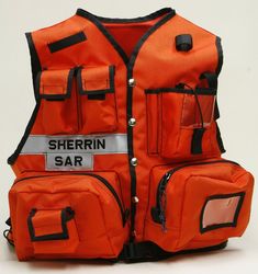 an orange vest that says sherrin sar on the front, and two pockets at the back