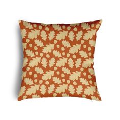 an orange pillow with leaves on it