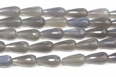 several grey and white glass beads on a white background