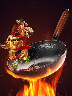 a frying pan is on fire with some food in it and flames around it