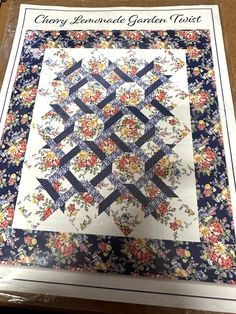 the front cover of a book with flowers on it and an image of a flowered quilt