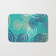 a blue and yellow bath mat with swirls on the front, in an abstract manner