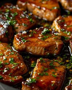 some meat is cooking in a pan with sauce and parsley on the top,