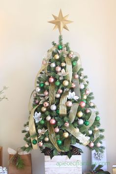 a decorated christmas tree with gold and green ornaments