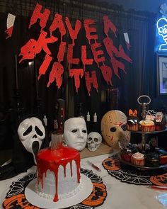 a table topped with cakes and halloween decorations