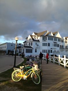 several bicycles parked on the side of a wooden walkway