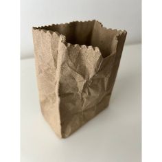 a brown paper bag sitting on top of a white table