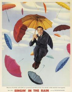 a man flying through the air while holding onto an umbrella in front of colorful umbrellas