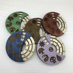 six wooden magnets with different designs on them