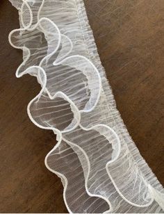 white sheer lace on wood flooring