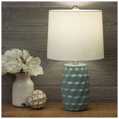 Base Dimensions: 5" W x 5" D Shade Dimensions: 9" H x 10.75" W x 10.75" D Full Height: 19.75" Cord Length: 62" Bulb Type: A 60W Power Source: Corded Electric Material: Ceramic, Fabric & Metal Color: Light Blue, White & Silver Quantity: 1 Enhance your home with a pop of color using this Blue Geometric Ceramic Lamp. The base boasts a design of a raised geometric pattern in a glossy blue color. Coordinate it with other soft, neutral tones to give your space some nautical charm. Electric Material, Blue Table Lamp, Frame Light, Blue Table, Ceramic Lamp, Color Light Blue, Hobby Lobby, Neutral Tones, Metal Color