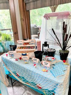 there are many items on the table that is set up for an outdoor event or party