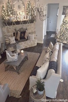 the living room is decorated for christmas with white and silver decorations on the mantles