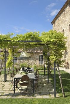 an outdoor dining area with table and chairs