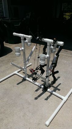 an assortment of fishing rods and reels on the ground in front of a car