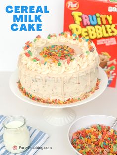 cereal milk cake with sprinkles and fruity pebbles next to the box