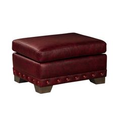 a red ottoman sitting on top of a wooden table