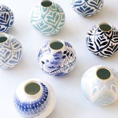 several blue and white vases with designs on them