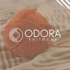 a ball of yarn sitting on top of a bed next to the words odraa knitwear