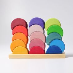 a stack of colorful wooden toys on a white background