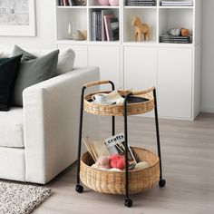 a living room with a couch, coffee table and bookshelf in it's corner