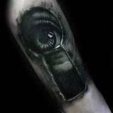 a man's arm with a black and white tattoo on it that has an eye in the middle