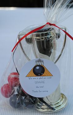 a silver cup sitting on top of a table next to some candies in a bag