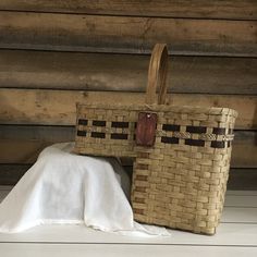 two woven baskets sitting on top of a wooden floor