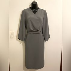 Gorgeous And Form Fitting August 1 Eight Boutique Brand. 3 1/4 L Sleeves With Detail, V Neck Wrap Style Front, Pockets, Mid Length, Grey Color, Zip Back, Size Medium! Grey Dress, August 1, Boutique Brands, Neck Wrap, Grey Color, Gray Dress, Wrap Style, Mid Length, Gray Color