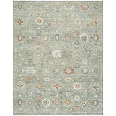 an area rug with many different colors and designs on it, including blue, green, beige