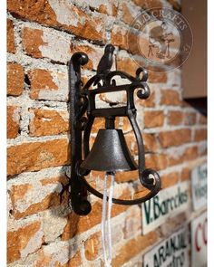 the bell is attached to the brick wall