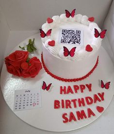 a birthday cake with a qr code on it and red roses next to it