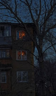 an apartment building with windows lit up at night