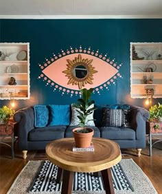 a living room filled with furniture and a painting on the wall above it's coffee table