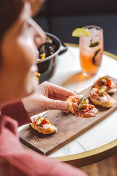 a woman sitting at a table eating food