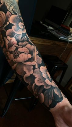 a man's arm with flowers on it