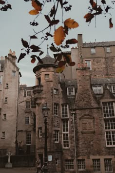 an old building with lots of windows and a street light in front of it on a cloudy day