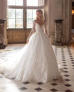 a woman in a white wedding dress standing on a checkered floor with her arms behind her back