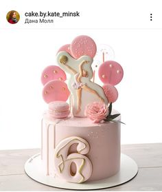 there is a cake that has been decorated with pink and gold decorations