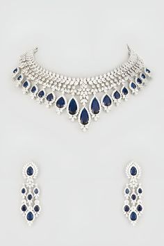 Silver toned choker necklace with blue stones and cubic zircon diamonds. Comes with matching pair of dangler earrings. - Aza Fashions Blue Hand Set Bridal Necklace For Reception, Elegant Blue Necklace For Reception, Elegant Blue Necklace For Receptions, Elegant Blue Diamond Jewelry, Blue Diamond Hand Set Jewelry, Dazzling Blue Diamond Bridal Necklace, Fine Jewelry Sets With Diamonds In Blue, Elegant Blue American Diamond Jewelry, Party Blue American Diamond Jewelry