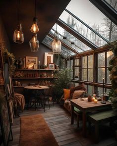 a room filled with lots of windows next to a wooden table and chairs on top of a hard wood floor