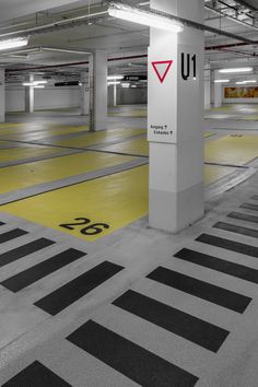 an empty parking garage with yellow and black markings