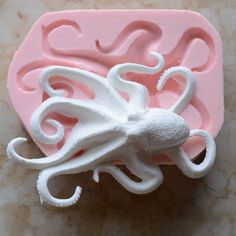 a pink and white mold with an octopus on it