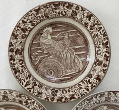 three brown and white plates with designs on them