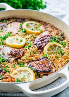 a pan filled with rice and lemon slices