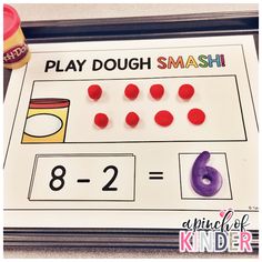 a printable play dough smash game with numbers and candy on the table next to it