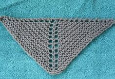 a crocheted triangle sitting on top of a blue towel