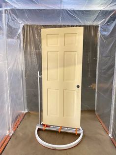 a white door in a room with plastic covering