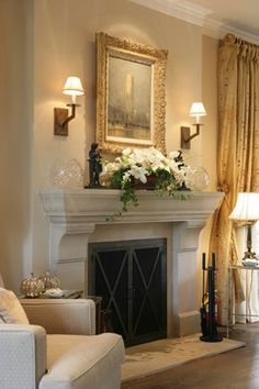 an image of a living room with a fireplace and pictures on the wall above it