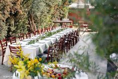 an outdoor dining area with tables and chairs set up for a formal dinner or party